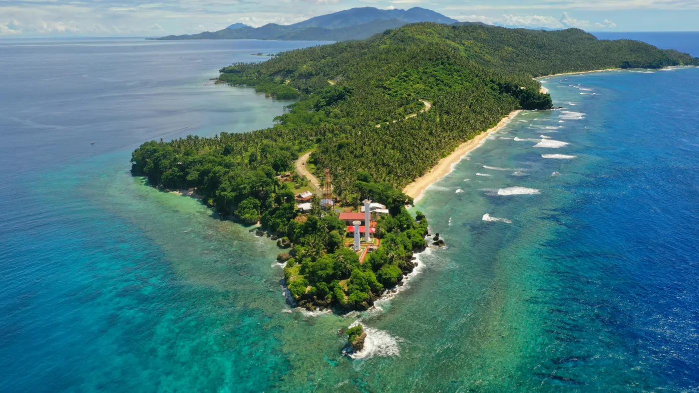Aerial view of a tropical island with a lighthouse and infrastructure